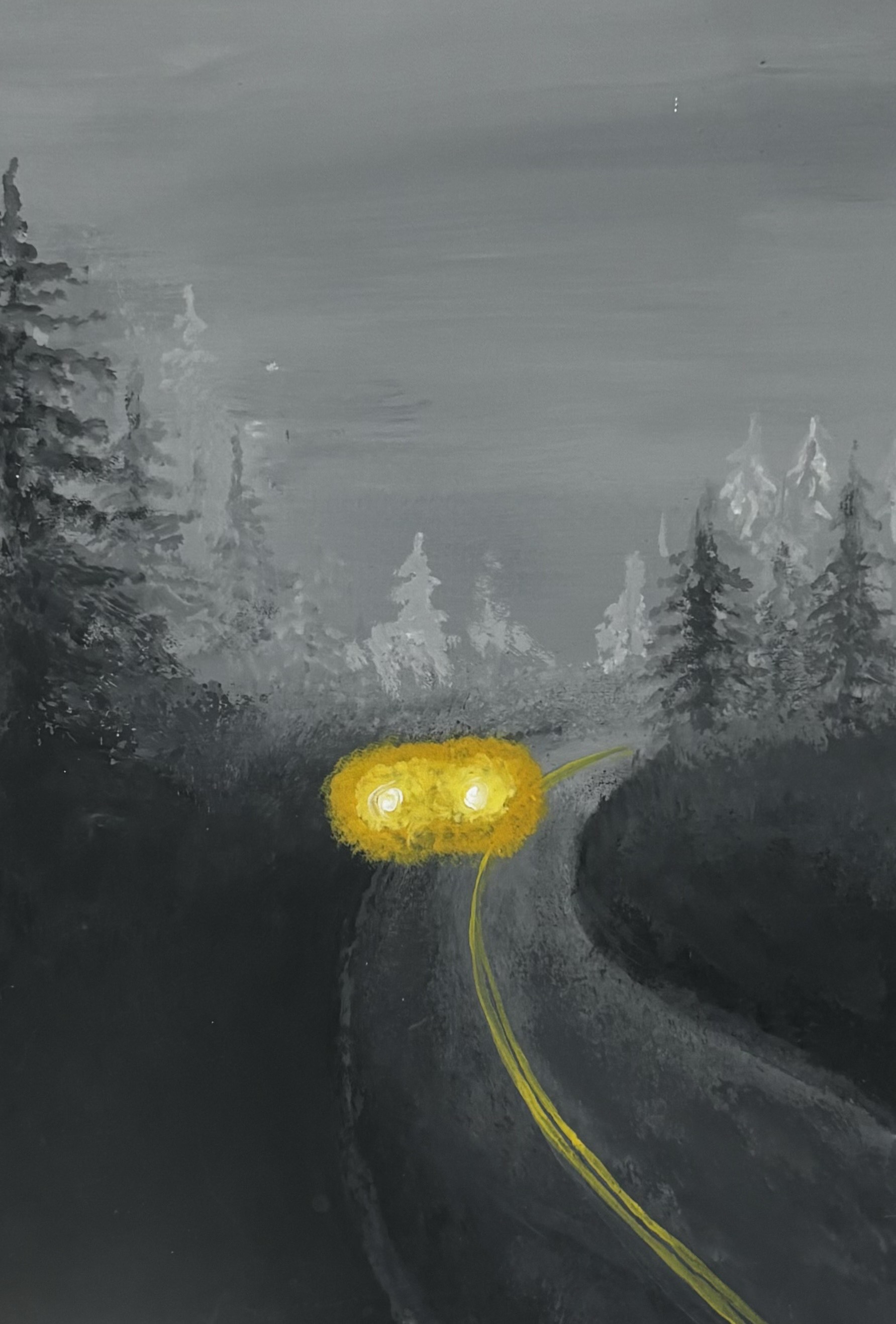 foggy road with yellow glowing car lights